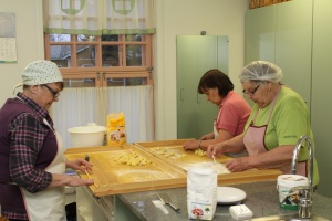 Three bakers shaping the twists.