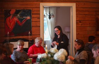 Knitters sitting in front of a table.