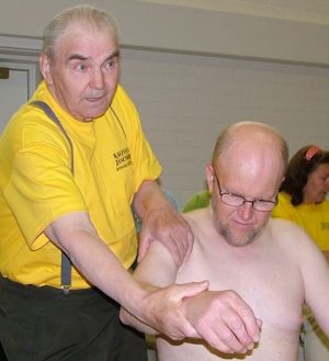 Healer treating a customer's arm.