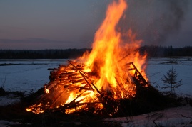 Bonfire burning on a dark evening.