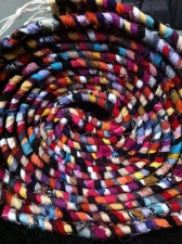 A colorful rolled up rag rug.