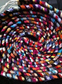 A colorful rolled up rag rug.