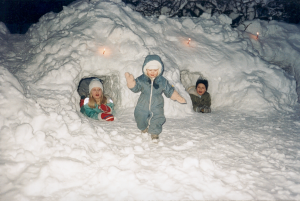 Small children playing in the snow.