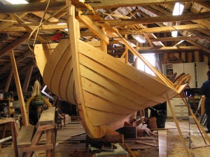 An unfinished clinker boat.