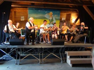 Musical saw players on stage.