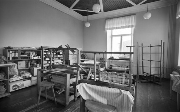 Black and white picture of a room with a loom in it.